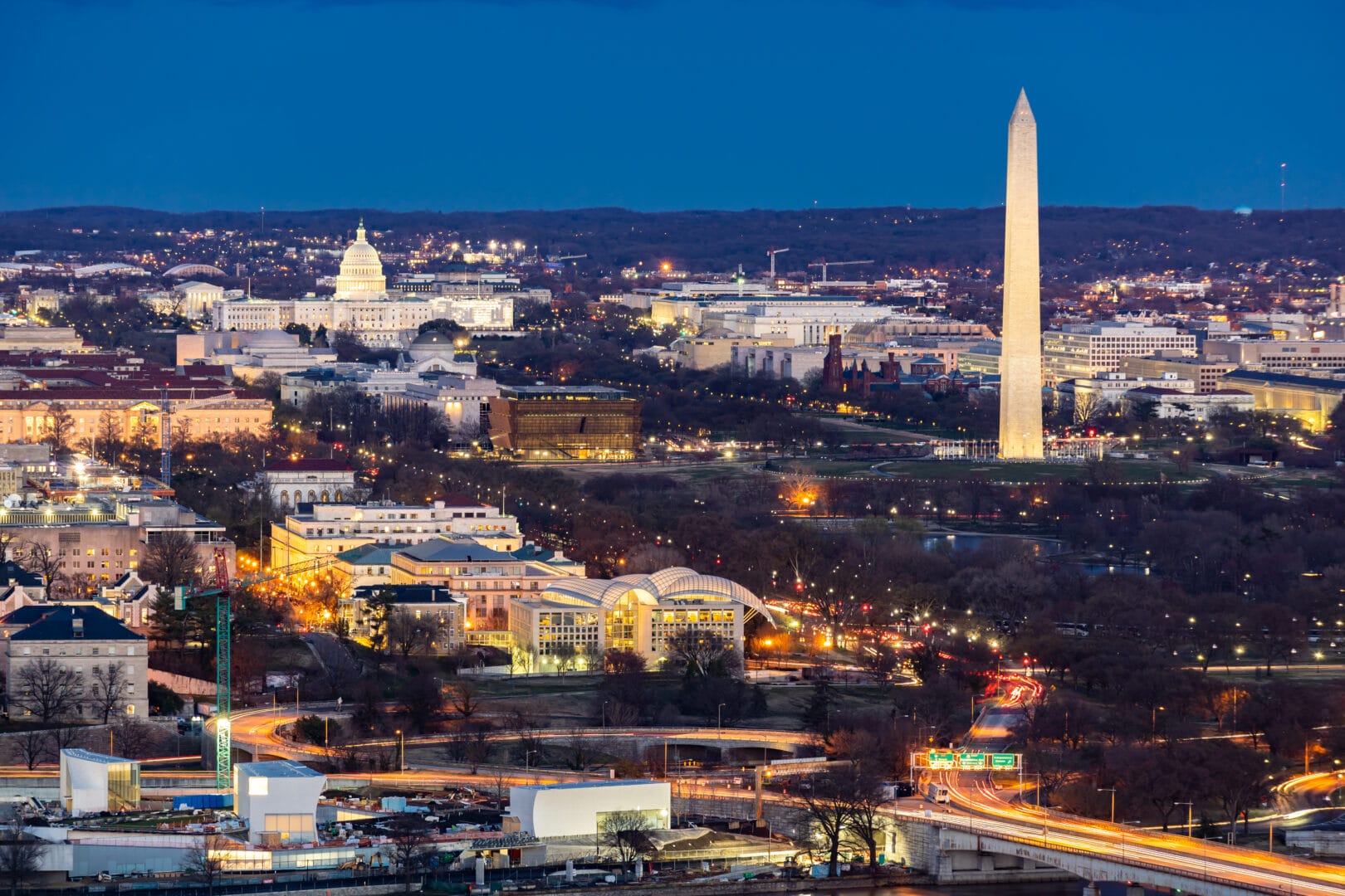 Illuminated Washington DC with view of the Washington Monument and the White House.